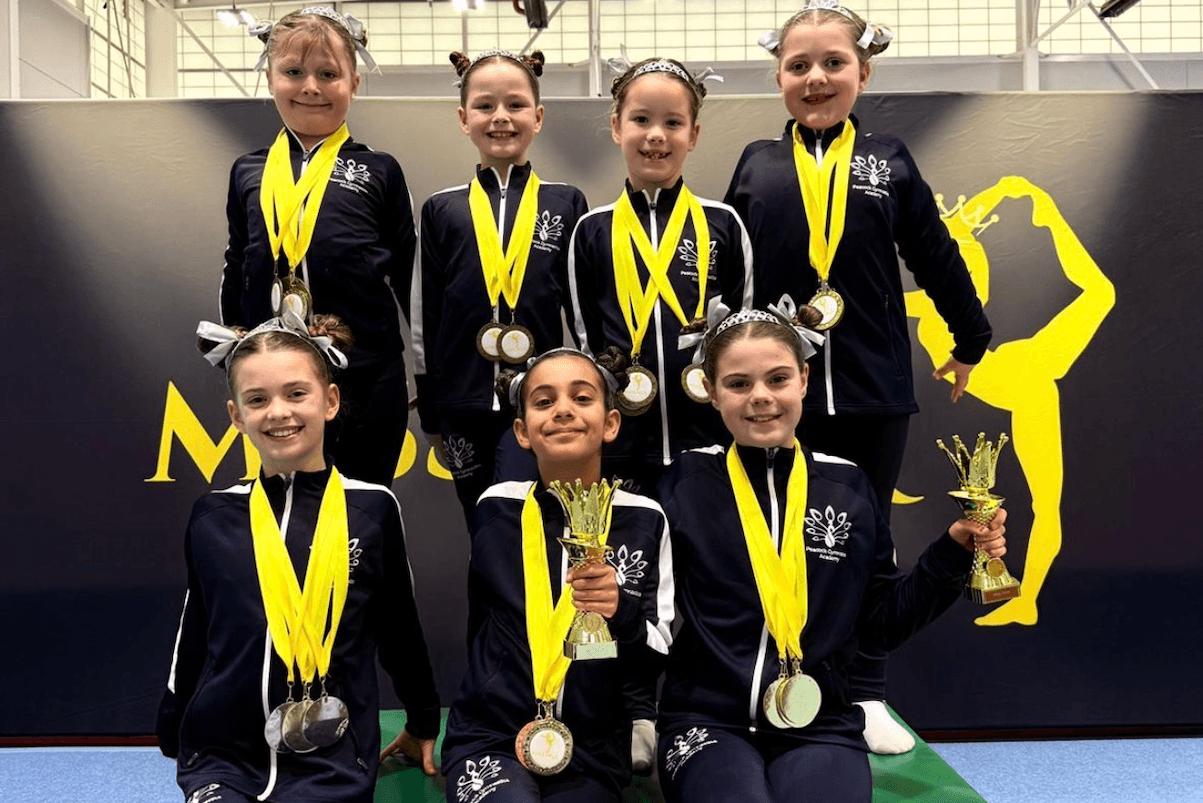Gymnasts celebrating with medals at an NGA UK event