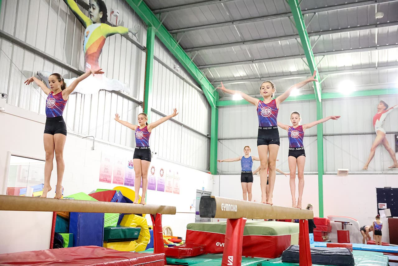 NGA UK gymnasts performing on beams